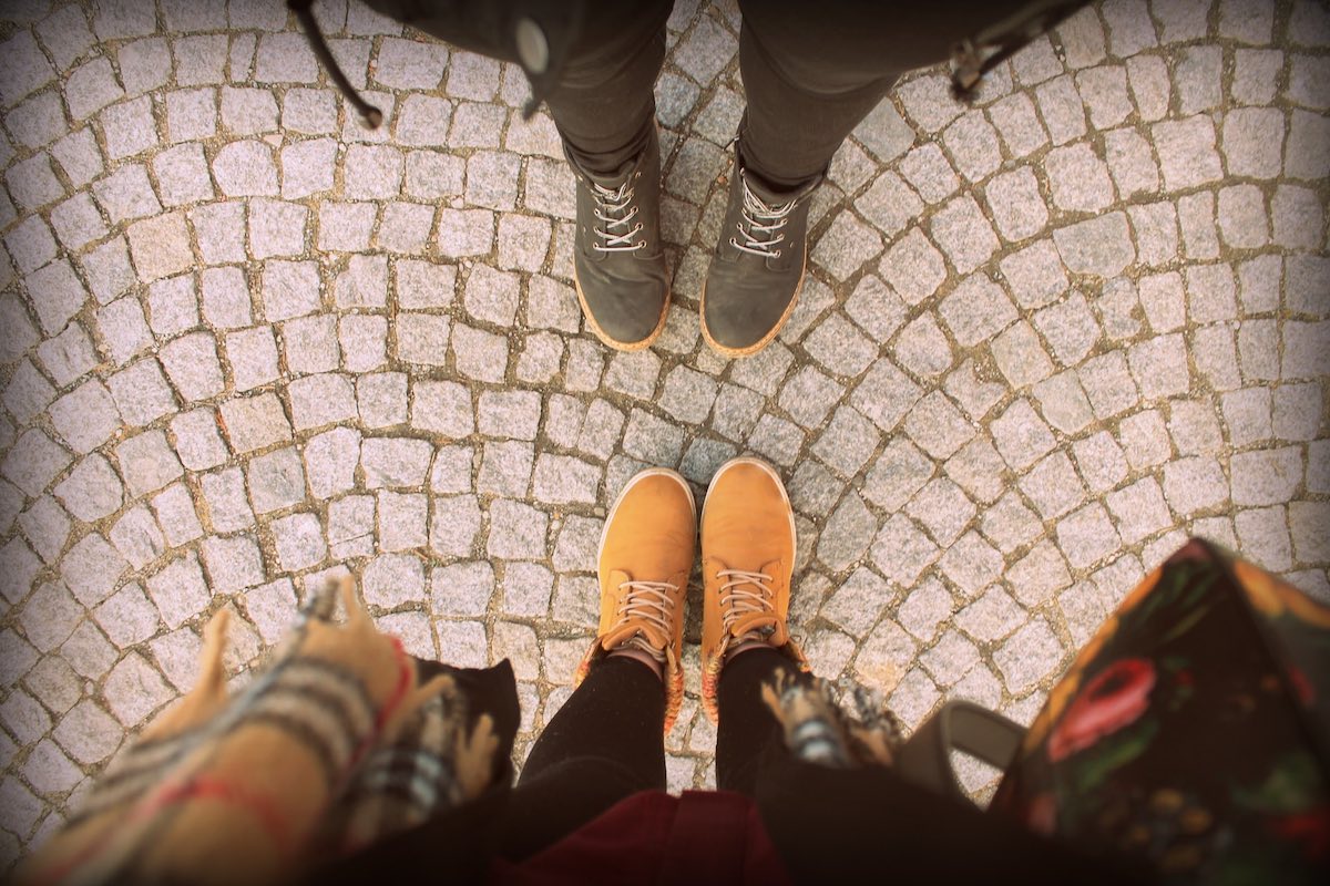 view of two pairs of feet facing each other