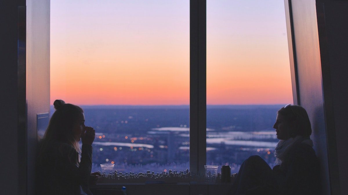 Two people talking in a window